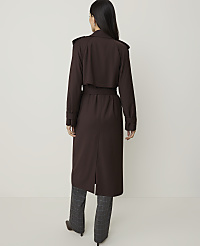 A woman in a brown trench coat and plaid pants stands against a plain, light-colored background. carousel Product Image 2