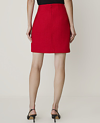 A woman in a red tweed skirt and black heels stands against a plain, light-colored background. carousel Product Image 6