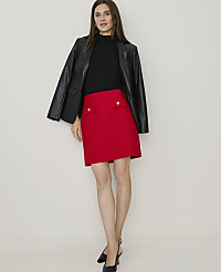 A woman in a red tweed skirt and black heels walks away from the camera against a plain white background. carousel Product Image 4