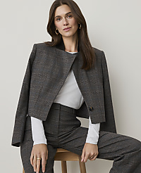 A woman in a plaid suit sits against a plain, light-colored background. carousel Product Image 7