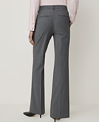 A person wearing gray pinstripe flared pants and a pink blouse stands against a plain, light-colored background. carousel Product Image 3