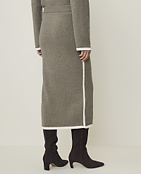 A person wearing a taupe knit midi skirt and dark brown boots stands against a plain, light background. carousel Product Image 3