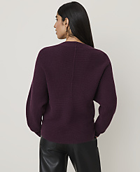 A woman in a burgundy ribbed sweater and black leather pants stands against a plain, light-colored background. carousel Product Image 2
