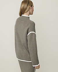 A woman in a taupe sweater and skirt stands against a plain, light gray background. carousel Product Image 2