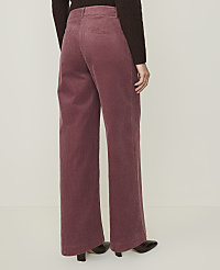 A person wearing rose-colored corduroy pants and dark shoes stands against a plain, light-colored background. carousel Product Image 3