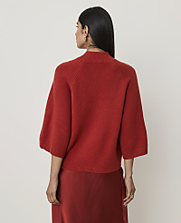 A woman in a rust-colored sweater and skirt stands against a plain white background. carousel Product Image 2