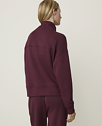 A woman in a burgundy sweatshirt and matching pants stands against a plain white background. carousel Product Image 2