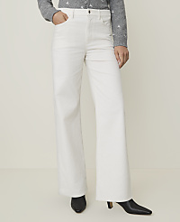 A person wearing white wide-leg pants and black heeled boots stands against a plain, light-colored background. carousel Product Image 2