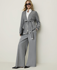 A woman in a grey belted cardigan and wide-leg pants stands against a plain, light-colored wall. carousel Product Image 4