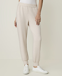 A person stands in light-colored sweatpants and white sneakers against a plain, light background. carousel Product Image 2