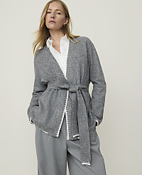 A woman in a grey cardigan and grey pants stands against a plain, light grey background. carousel Product Image 1