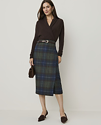 A woman in a brown sweater and plaid skirt stands against a plain background. carousel Product Image 4