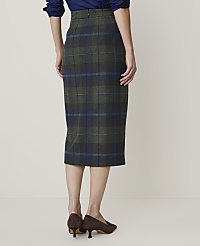 A woman in a plaid pencil skirt and brown heels stands against a plain, light-colored background. carousel Product Image 3