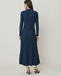 A woman in a teal knit dress with a pleated skirt stands against a plain, light-colored background. carousel Product Image 2