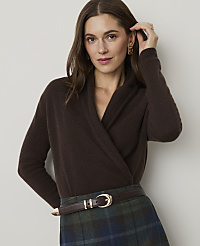 A woman in a brown wrap sweater and plaid skirt stands against a plain background. carousel Product Image 1