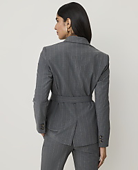 A woman in a pinstripe suit stands against a plain, light gray background. carousel Product Image 2