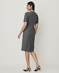 A woman in a grey pinstripe dress and black heels stands against a plain, light-colored background. carousel Product Image 2