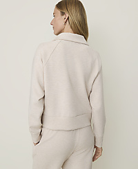 A woman in a cream-colored sweatshirt and pants stands against a plain, light-colored background. carousel Product Image 2