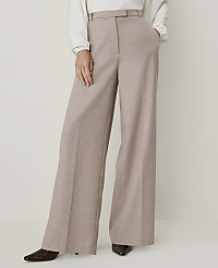 A person stands in wide-leg beige trousers and dark shoes against a plain, light background. carousel Product Image 2