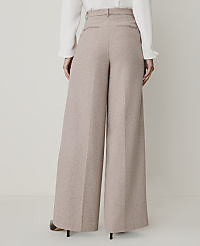 A person wearing wide-leg beige trousers and a white blouse stands against a plain, light-colored background. carousel Product Image 3