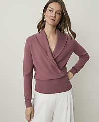 A woman in a rose-colored wrap sweater stands against a plain, light background. carousel Product Image 1