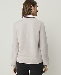A woman in a light-colored sweater and dark pants stands against a plain white background. carousel Product Image 2