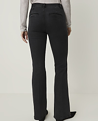 A person wearing dark wash flared jeans and a light grey sweater stands against a plain white background. carousel Product Image 3