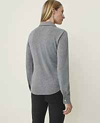A woman in a grey long-sleeved shirt and black jeans stands against a plain, light-colored background. carousel Product Image 2