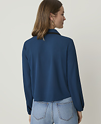 A woman in a teal blouse and jeans stands against a plain white background. carousel Product Image 2