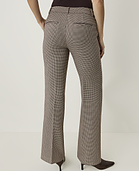 A person wearing brown and white checkered flared pants stands against a plain white background. carousel Product Image 3