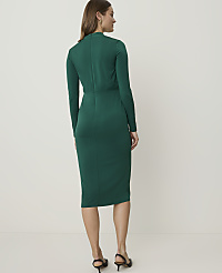 A woman in a green dress stands against a plain, light-colored background. carousel Product Image 2