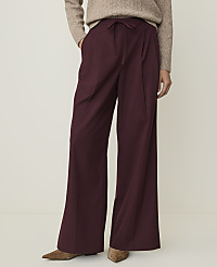 A person in a beige sweater and burgundy wide-leg pants stands against a plain white background. carousel Product Image 2