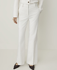 A person stands in white flared trousers and dark pointed shoes against a plain white background. carousel Product Image 2