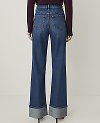 A person wearing wide-leg denim jeans with cuffed hems stands against a plain white background. carousel Product Image 3