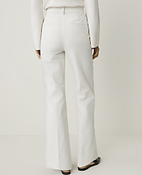 A person wearing white flared trousers stands against a plain white background. carousel Product Image 3
