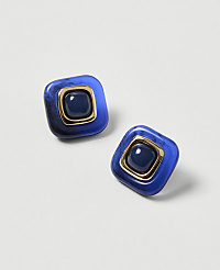Two square blue earrings with gold trim and a dark blue center stone rest on a light gray background. carousel Product Image 1