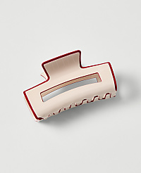 A light pink claw clip with a dark red trim rests on a plain white background. carousel Product Image 1