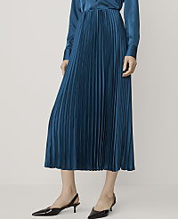 A woman in a teal pleated skirt and black slingback heels stands against a plain white background. carousel Product Image 2