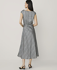 A woman in a plaid dress stands against a plain, light-colored background. carousel Product Image 2
