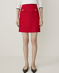 A woman in a red tweed mini skirt with gold button pockets and black heels stands against a plain white background. carousel Product Image 3