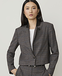 A woman in a plaid jacket and pants stands against a plain, light gray background. carousel Product Image 1