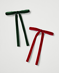 Two velvet bow ties, one green and one red, lie on a plain white background. carousel Product Image 1