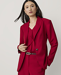 A woman in a red blazer and pants stands against a plain, light gray background. carousel Product Image 1
