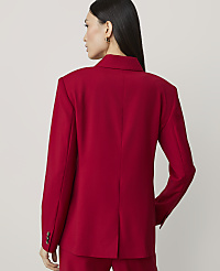 A woman in a red blazer stands against a plain, light-colored background. carousel Product Image 2
