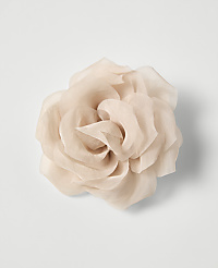 A delicate, pale pink fabric rose with layered petals is centered against a plain white background. carousel Product Image 1
