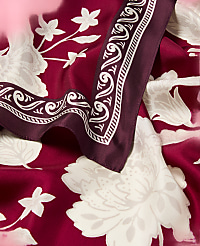 A burgundy silk scarf with a white floral pattern is draped over a matching fabric, with a decorative border visible in the foreground. carousel Product Image 2