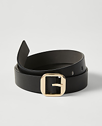 A black leather belt with a gold buckle is coiled on a plain white background. carousel Product Image 1