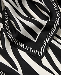 A black and white zebra-print scarf with a decorative border is laid out against a matching patterned background. carousel Product Image 2