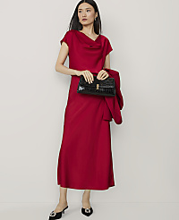 A woman in a red dress and heels stands with a black clutch and jacket against a plain white background. carousel Product Image 1