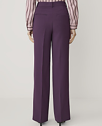 A person wearing purple wide-leg trousers and a striped blouse stands against a plain white background. carousel Product Image 2